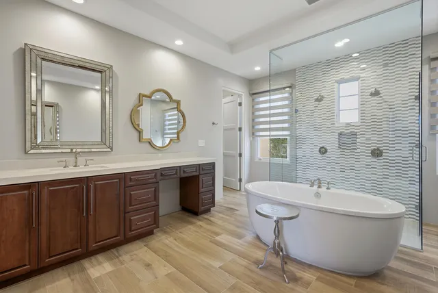 a spacious bedroom with a bed and a flat screen tv