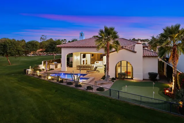 a view of a swimming pool and lounge chairs