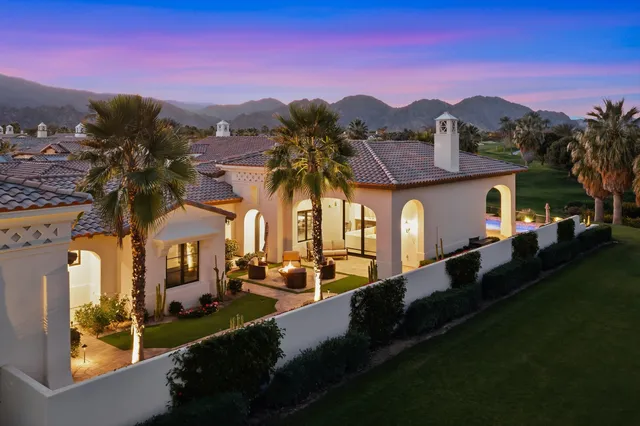a view of a chairs and table in patio with a lake view