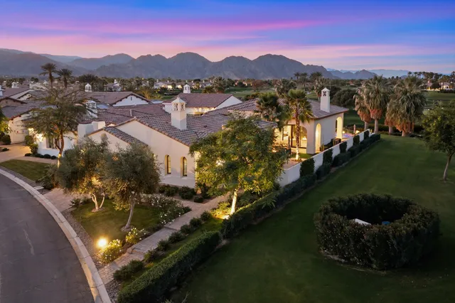 a view of a house with a yard and a swimming pool