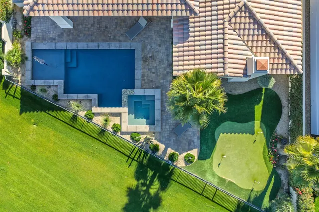 a dining room with wooden floor table and chairs