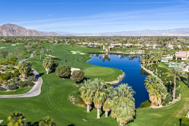 a view of a dining room with furniture wooden floor and chandelier