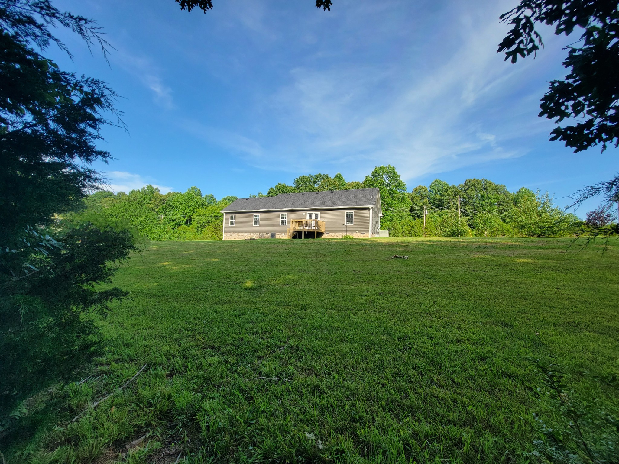 961 Big Springs Road Charlotte, TN 37036 - Photo 47 of 50 Peeking out the wooded area on your property into your spacious backyard and rear of home.