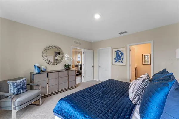 a bedroom with a bed and a couch