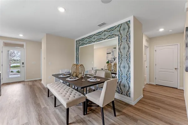 a dining room with furniture and wooden floor