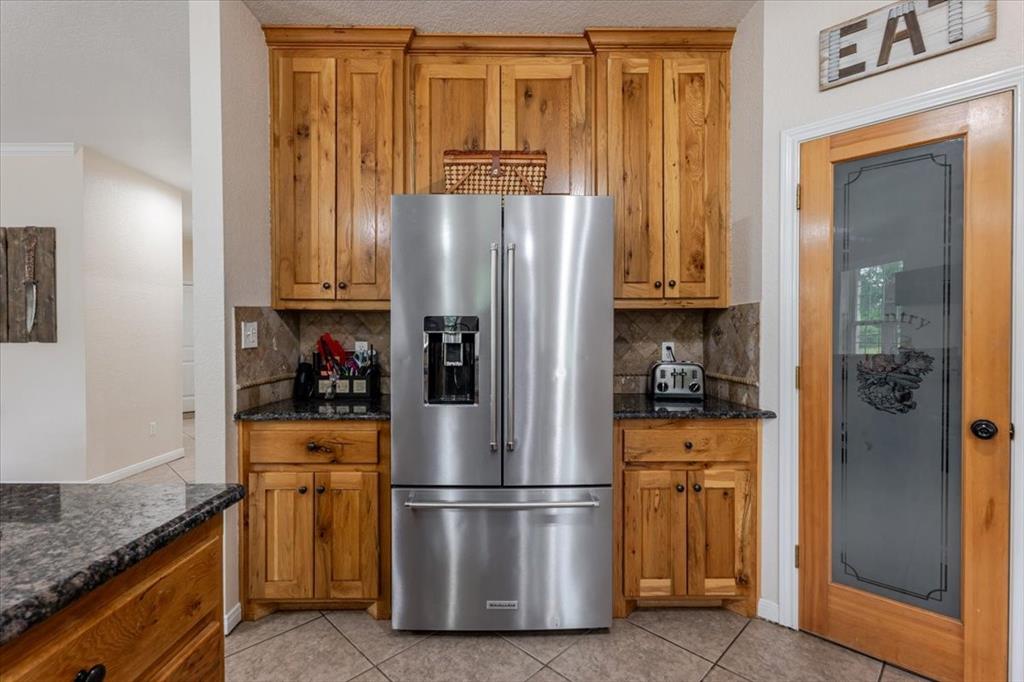 318 East Lone Star Road Poolville, TX 76487 - Photo 23 of 33 a white refrigerator freezer and a stove sitting inside of a kitchen