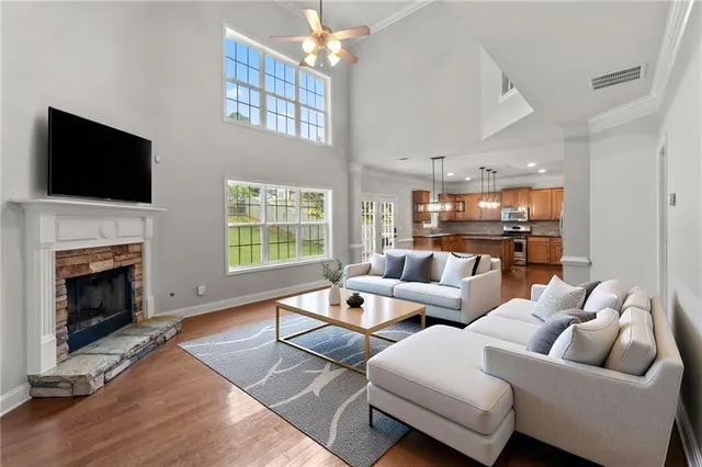 a living room with furniture fireplace and flat screen tv
