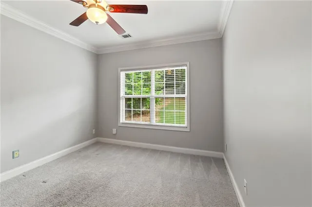 an empty room with fan and entrance