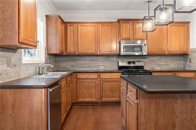 a view of a kitchen with wooden floor and window