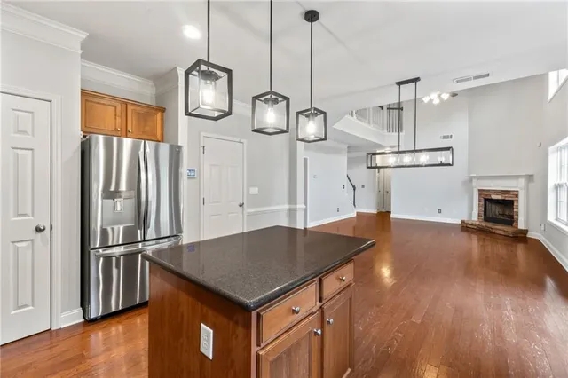 a kitchen with stainless steel appliances granite countertop a sink stove and cabinets