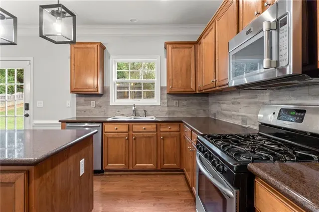 a view of staircase with lots of frames on wall and wooden floor