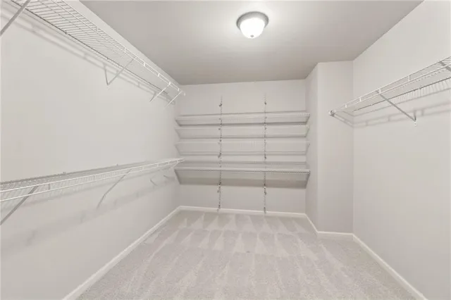 a view of a hallway with wooden floor and entryway