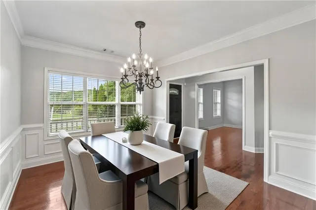 a view of a dining room with furniture window and wooden floor