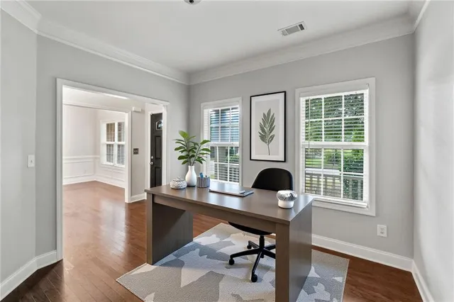 a view of a workspace with furniture and a window