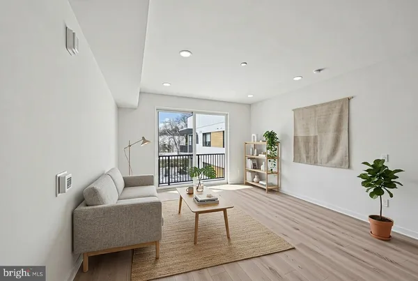 a living room with furniture and a potted plant