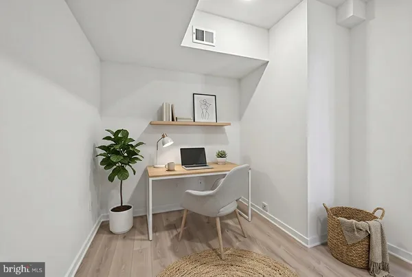 a workspace with furniture and window