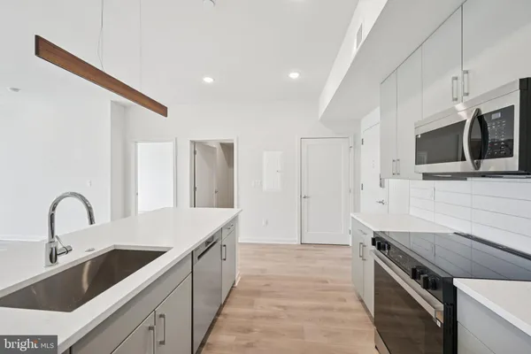 a kitchen with a sink and a stove top oven