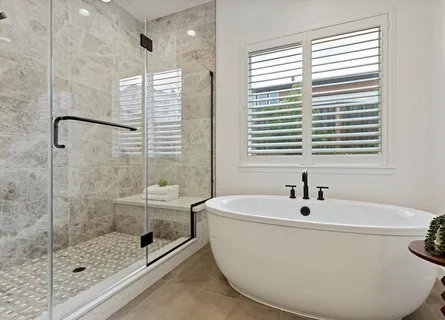 a bathroom with a granite countertop sink toilet a mirror a vanity and shower