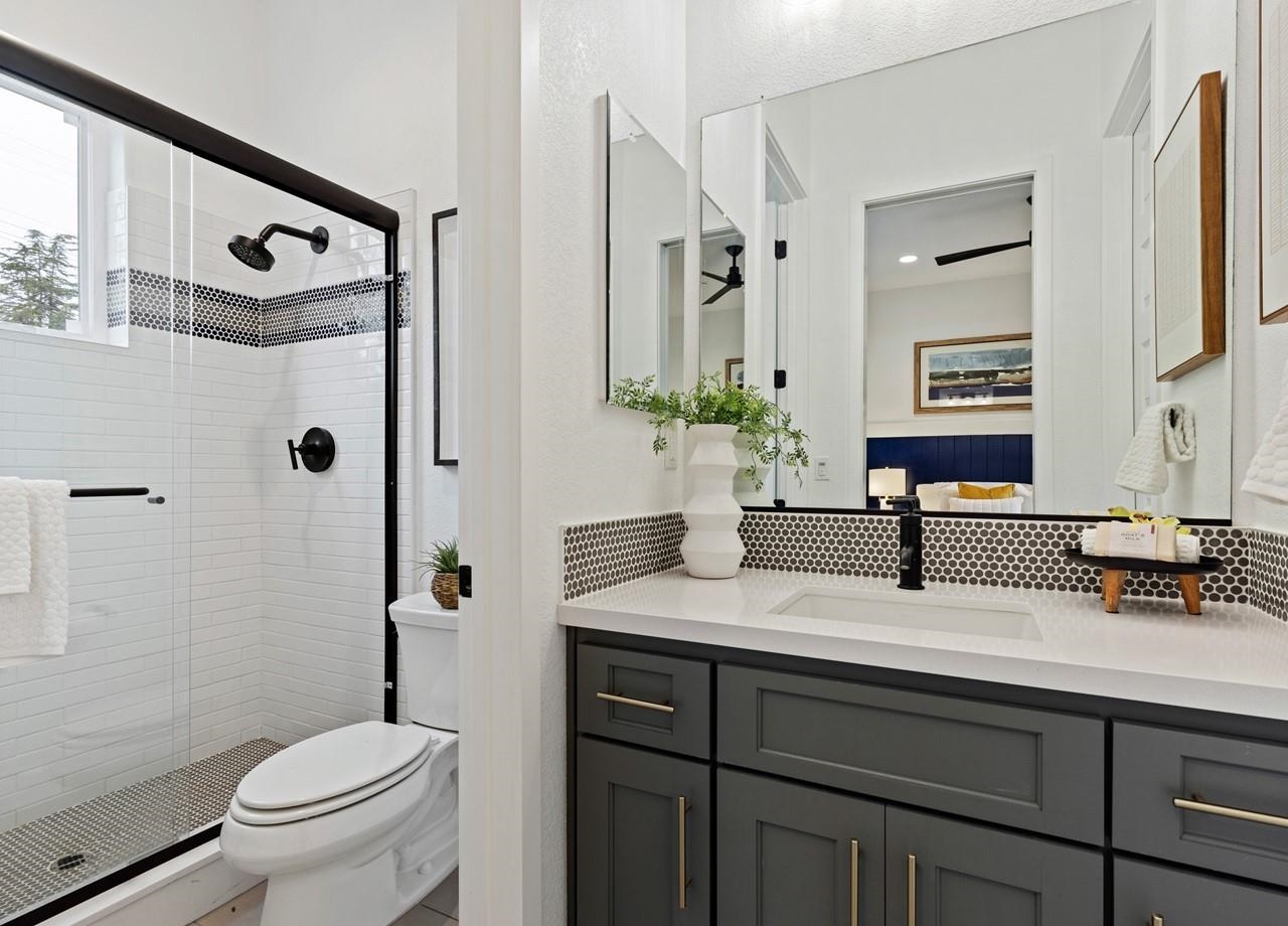 580 Boyd Road Pleasant Hill, CA 94523 - Photo 36 of 60 a bathroom with a granite countertop sink toilet a mirror a vanity and shower