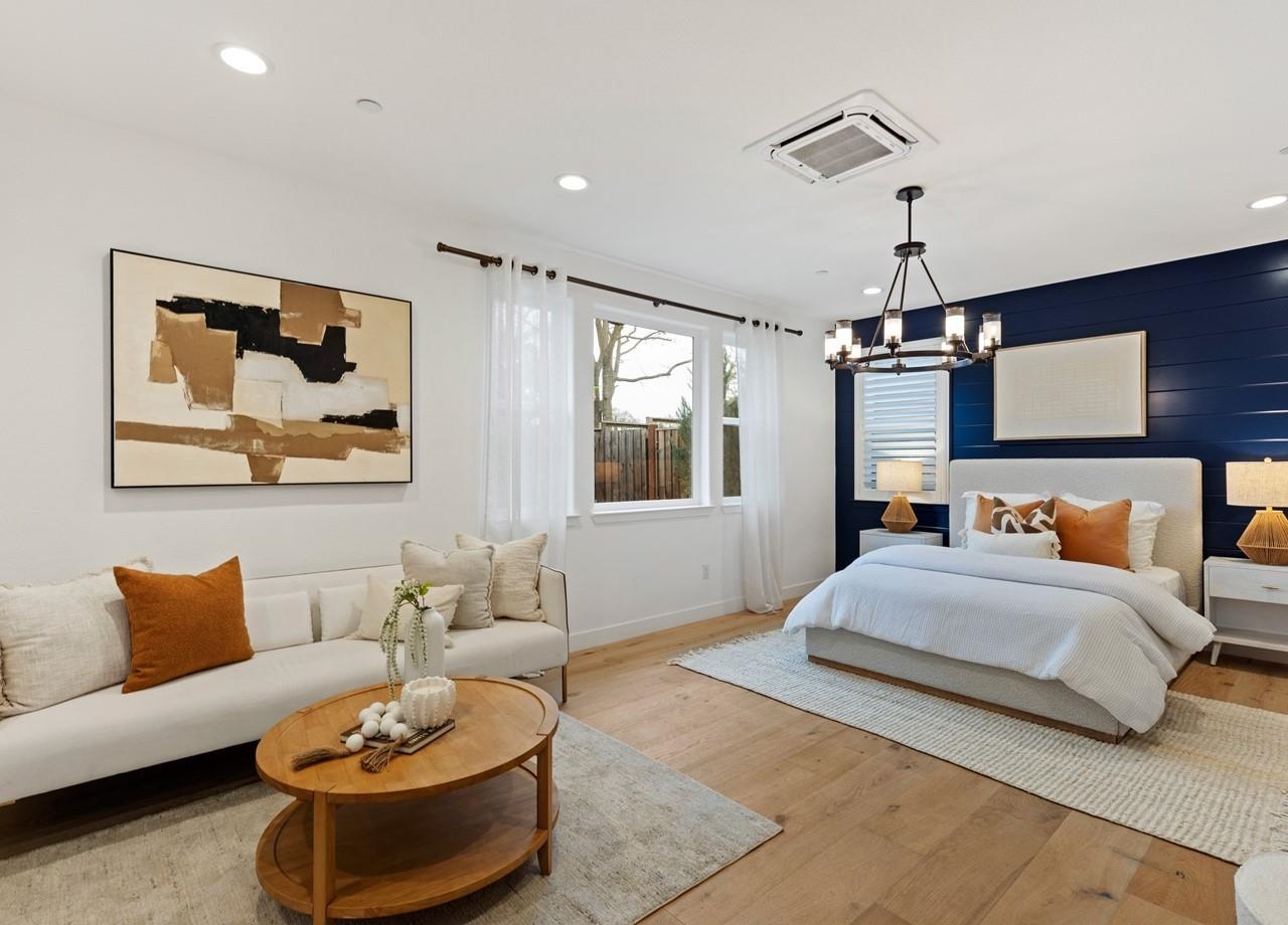 580 Boyd Road Pleasant Hill, CA 94523 - Photo 46 of 60 a bedroom with a large bed a couch and paintings on the wall