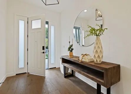 a kitchen with a table chairs sink and cabinets