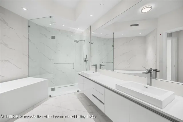 a spacious bathroom with a tub sink and mirror