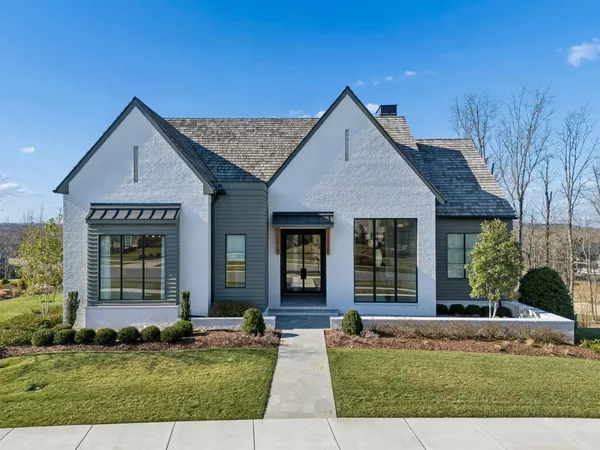 a front view of a house with a yard