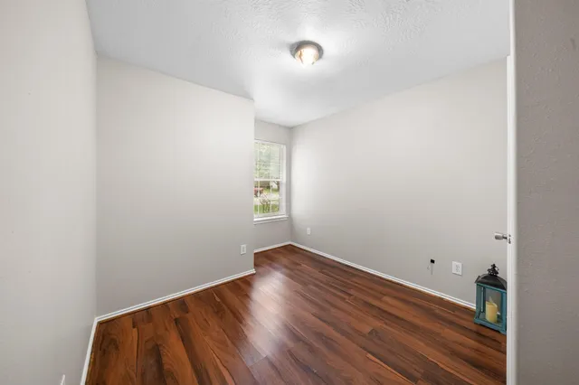 a view of room with wooden floor and fan