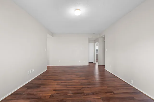 a view of an empty room and wooden floor