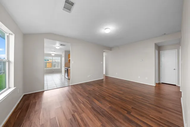 wooden floor in an empty room with a window