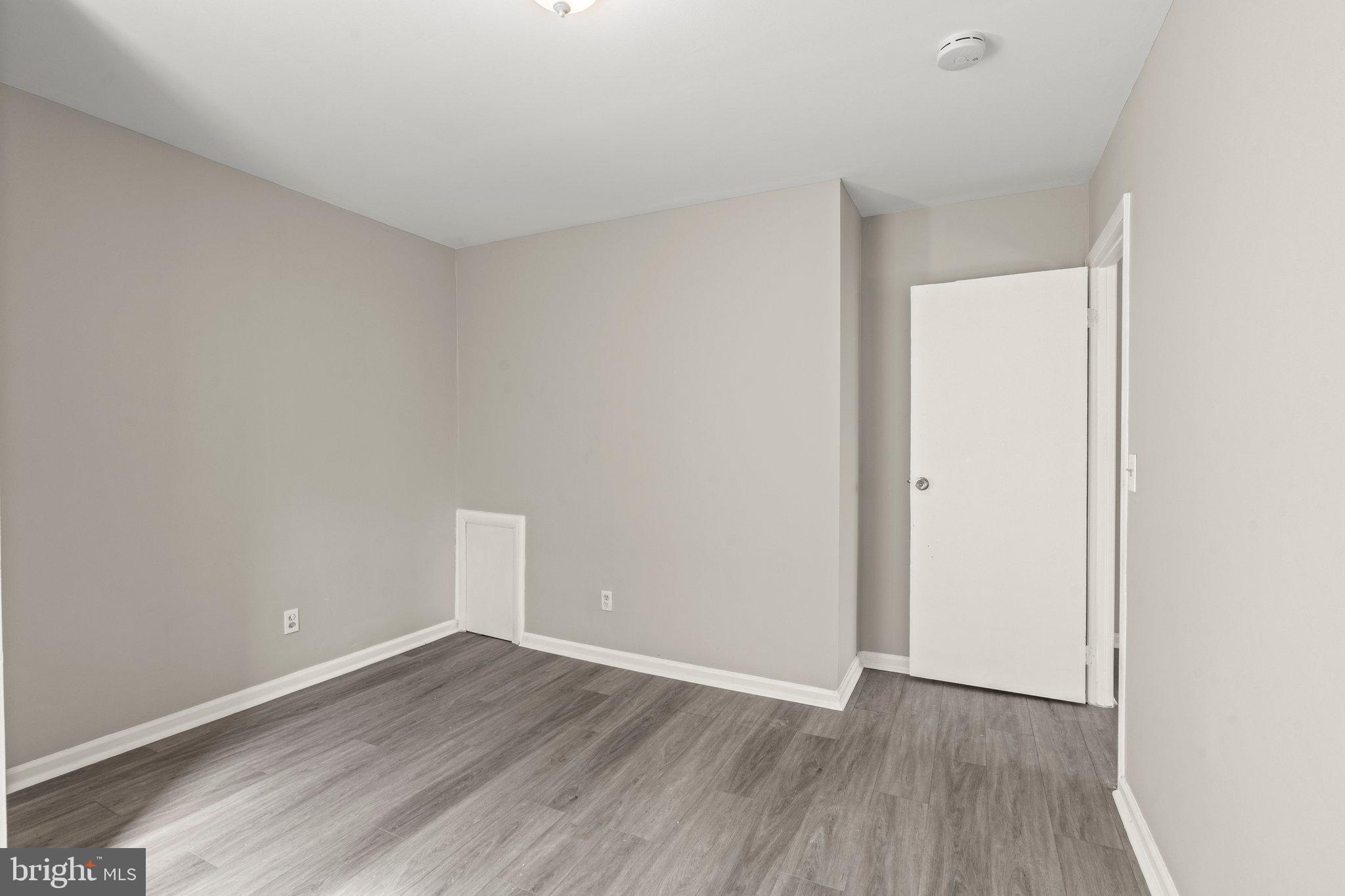 1004-6 South 52nd Street, Unit 6 2F Philadelphia, PA 19143 - Photo 7 of 10 a view of an empty room with wooden floor