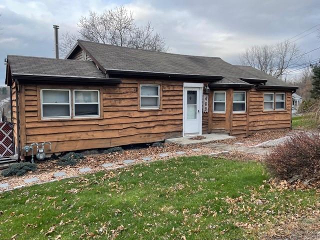 a front view of a house with a garden