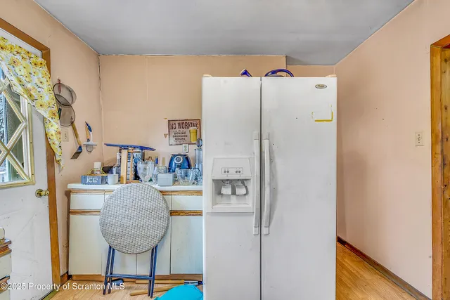 a kitchen with a sink a stove cabinetry and a refrigerator