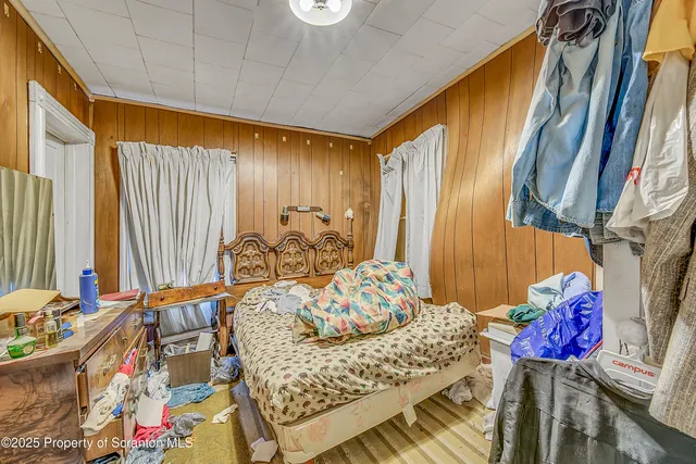 a view of walk in closet with clothes