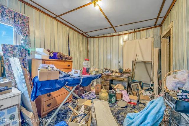 a living room with furniture a air conditioner vent and a window