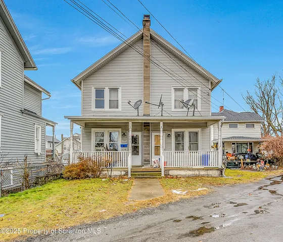 a view of a white house with a swimming pool
