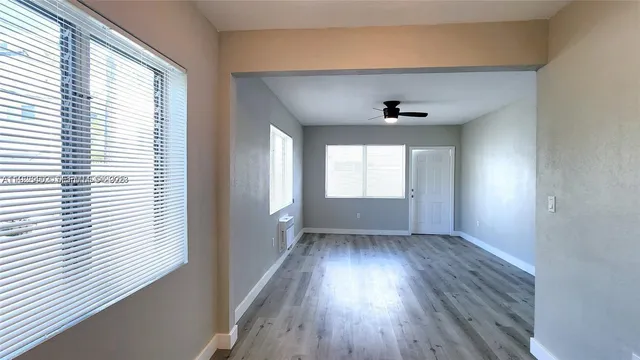 wooden floor in an empty room with a window