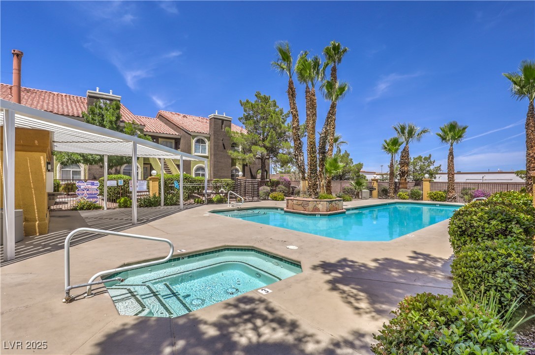 Community pool with a community hot tub, a patio, and a pergola
