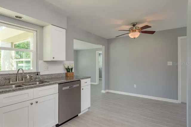 a kitchen with a sink cabinets and a window