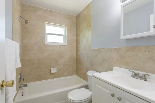 a bathroom with a sink toilet and bathtub