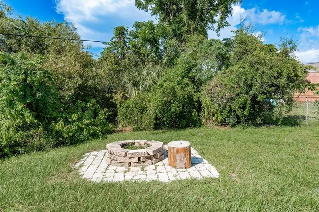 a view of a backyard with a garden and entertaining space