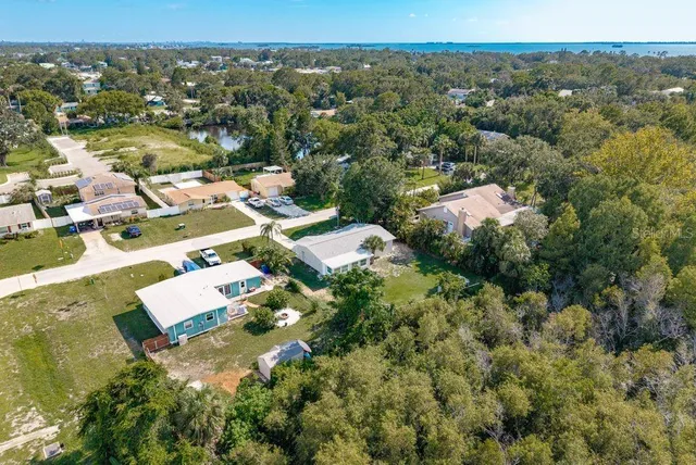 an aerial view of residential houses with outdoor space