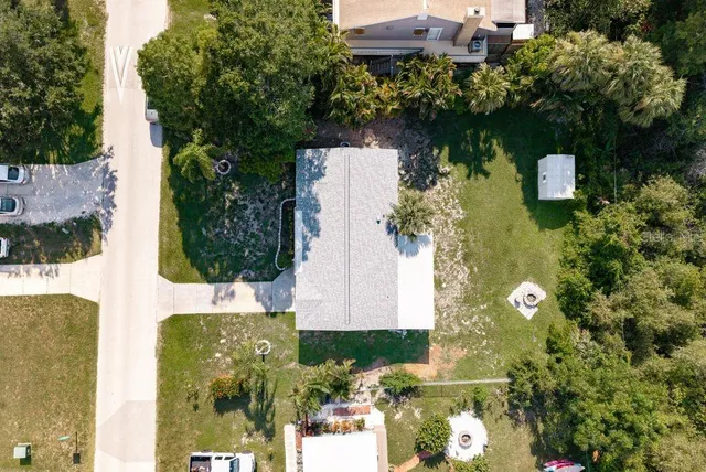 an aerial view of a houses with yard