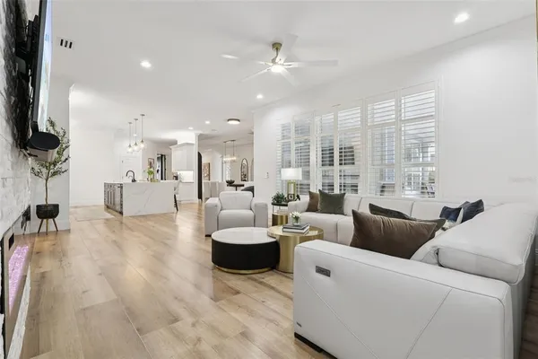 a kitchen with stainless steel appliances kitchen island granite countertop a sink a stove and a wooden floors