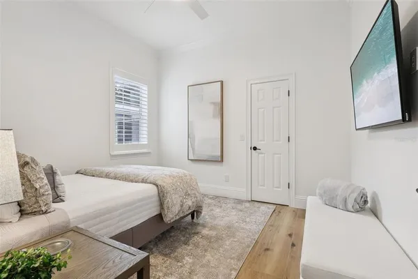 a bedroom with a bed and a chandelier