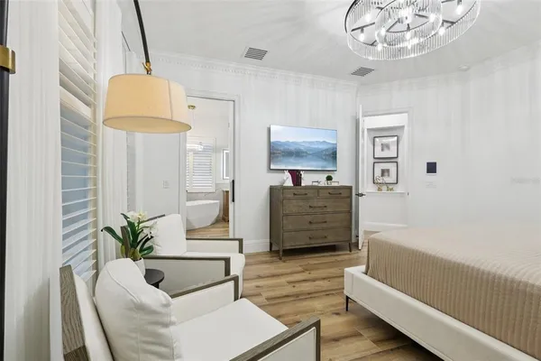 a dining room with furniture large windows and wooden floor