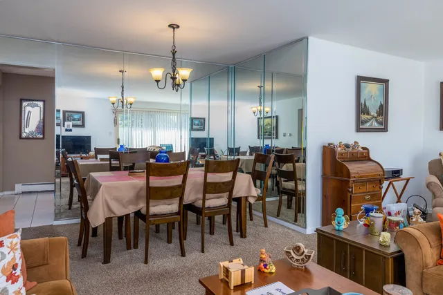 a view of a dining room with furniture and chandelier
