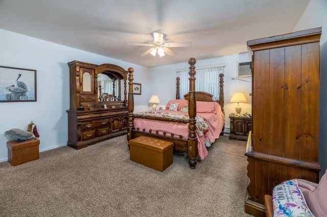 a bedroom with bed and a chandelier