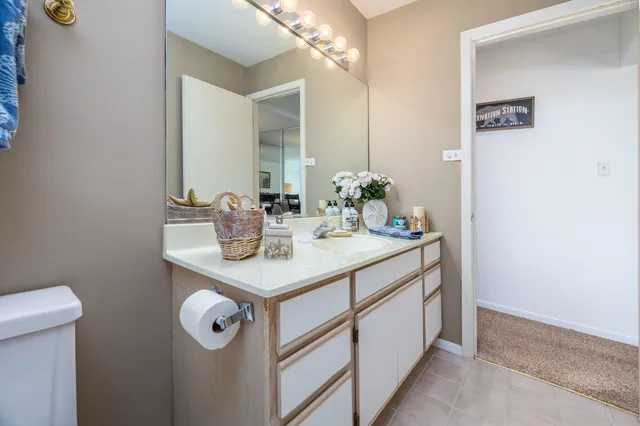 a bathroom with a sink a mirror and a toilet