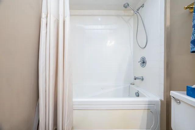 a bathroom with a bath tub with a shower